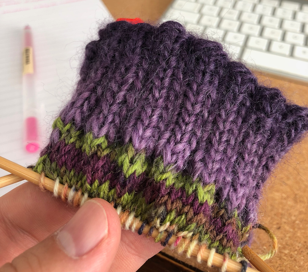 Sock knitting with contrasting yarns showing weight mismatch